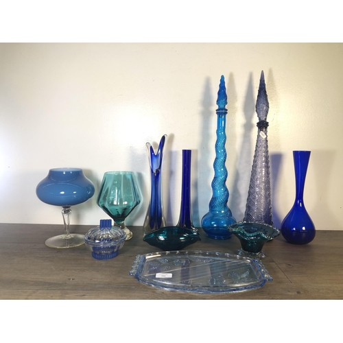 266 - Eleven pieces of mid 20th century blue glassware to include two genie bottles, Art Deco style lidded... 