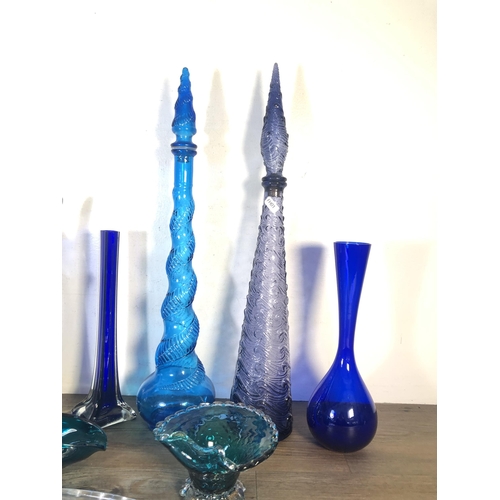 266 - Eleven pieces of mid 20th century blue glassware to include two genie bottles, Art Deco style lidded... 