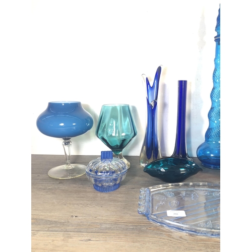 266 - Eleven pieces of mid 20th century blue glassware to include two genie bottles, Art Deco style lidded... 