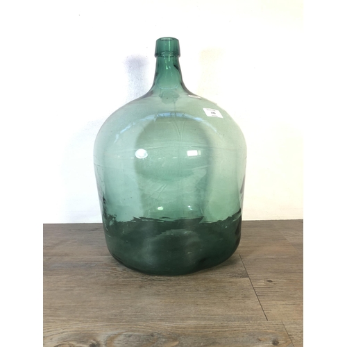 270 - A vintage green glass demijohn - approx. 45cm high