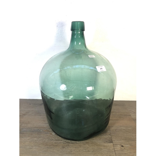 270 - A vintage green glass demijohn - approx. 45cm high