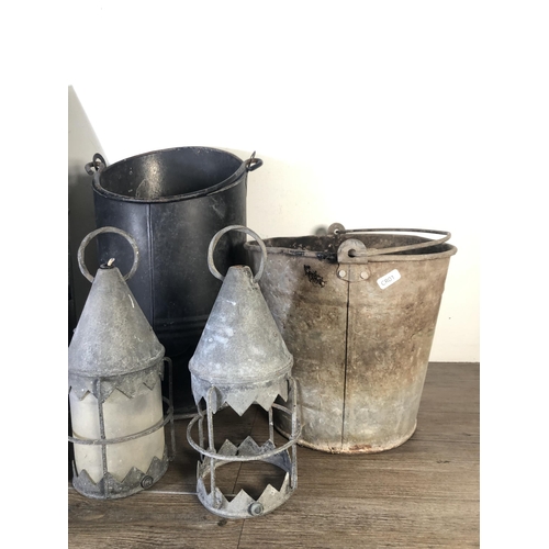 293 - Six pieces of metalware to include galvanised bucket, black metal coal scuttle, two hanging lanterns... 