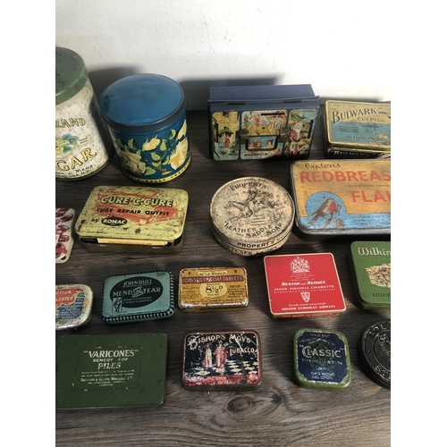 303A - A collection of vintage advertising tins