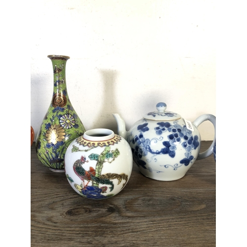 278 - Eight pieces of Oriental ceramics to include Chinese blue and white teapot, Japanese Satsuma bud vas... 