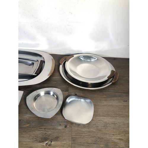 306 - Nine pieces of mid 20th century stainless steel kitchenware to include four teak handled trays etc.