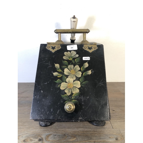 284 - An early 20th century hand painted black metal and brass coal scuttle with ceramic handled shovel - ... 