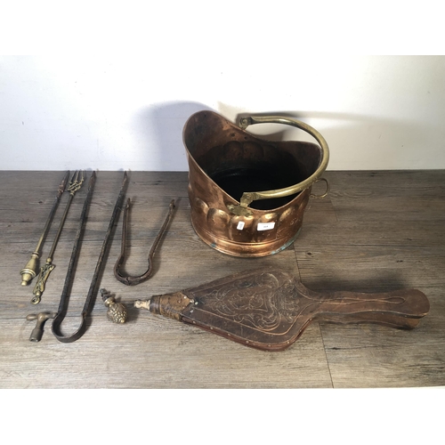 314 - Six vintage fireside accessories to include wood and leather fire bellows, copper coal scuttle, two ... 