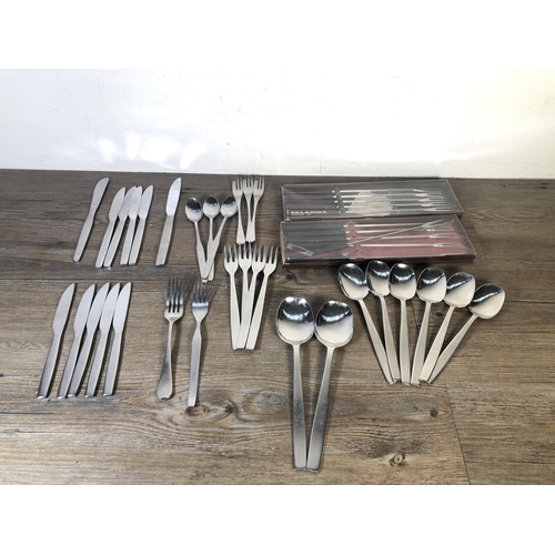 316 - A collection of mid 20th century stainless steel cutlery to include Viners of Sheffield, Selandia De... 