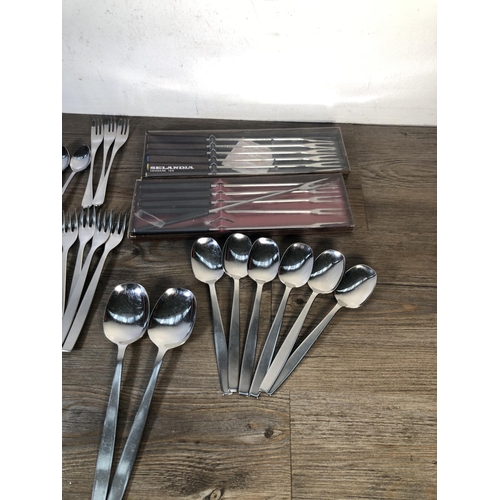 316 - A collection of mid 20th century stainless steel cutlery to include Viners of Sheffield, Selandia De... 