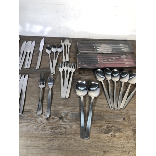 316 - A collection of mid 20th century stainless steel cutlery to include Viners of Sheffield, Selandia De... 