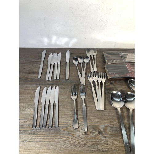 316 - A collection of mid 20th century stainless steel cutlery to include Viners of Sheffield, Selandia De... 