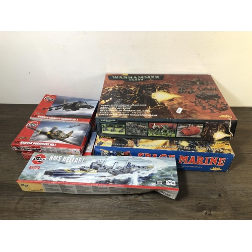 327 - A collection of model construction kits to include Airfix HMS Belfast, Airfix Hawker Hurricane MK.I,... 