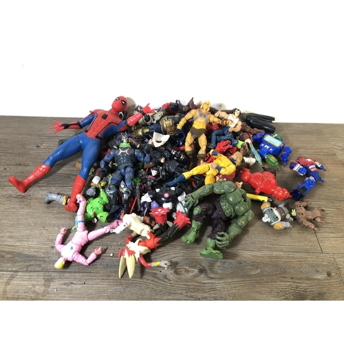 340 - A collection of plastic super hero figurines to include Spider Man, The Hulk etc.