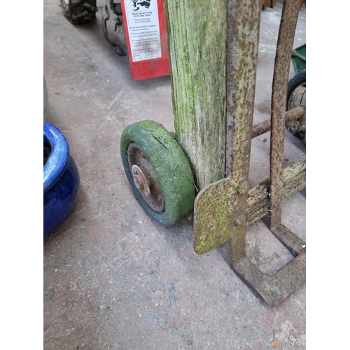 772 - An antique cast metal and wooden sack truck