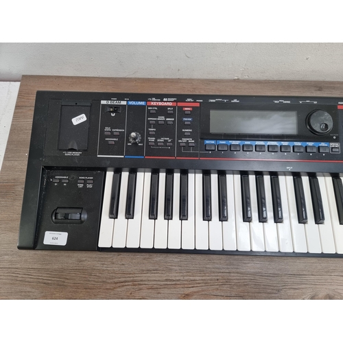 624 - A Roland Juno-Gi Synthesizer keyboard