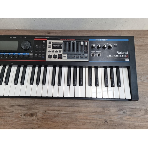 624 - A Roland Juno-Gi Synthesizer keyboard