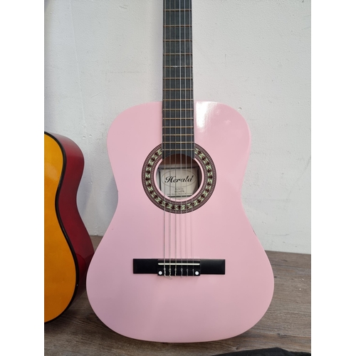 637 - Two child's nylon strung acoustic guitars, one cased pink Herald and one Music Alley