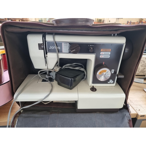 639 - A cased Jones VX520 electric sewing machine with foot pedal and instruction manual