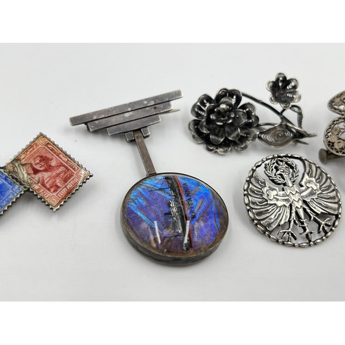 1107 - Five silver and white metal brooches to include Art Deco sterling silver and butterfly wing S. S. Br... 