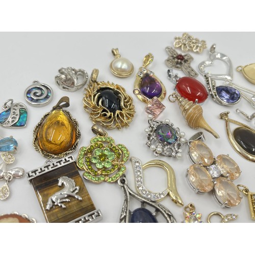 1117 - A collection of pendants to include cameo, abalone shell etc.