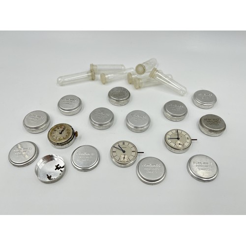 1130A - Twelve Longines 23mm movement holders containing two Longines movements and dials and one Malex