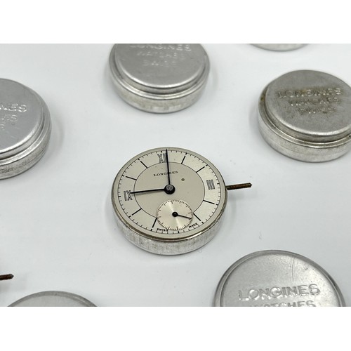 1130A - Twelve Longines 23mm movement holders containing two Longines movements and dials and one Malex