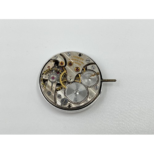 1130A - Twelve Longines 23mm movement holders containing two Longines movements and dials and one Malex