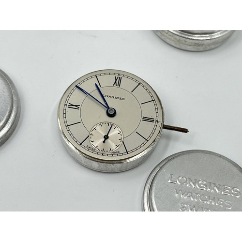 1130A - Twelve Longines 23mm movement holders containing two Longines movements and dials and one Malex