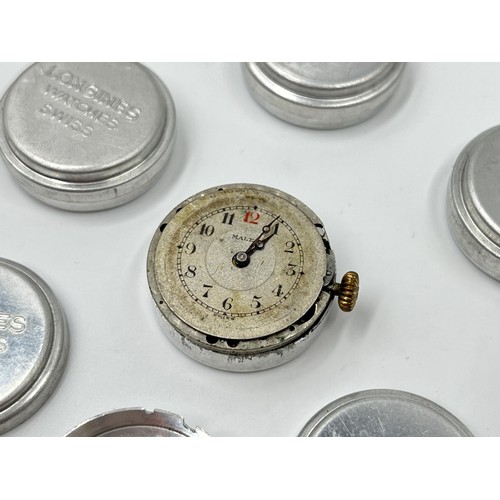 1130A - Twelve Longines 23mm movement holders containing two Longines movements and dials and one Malex