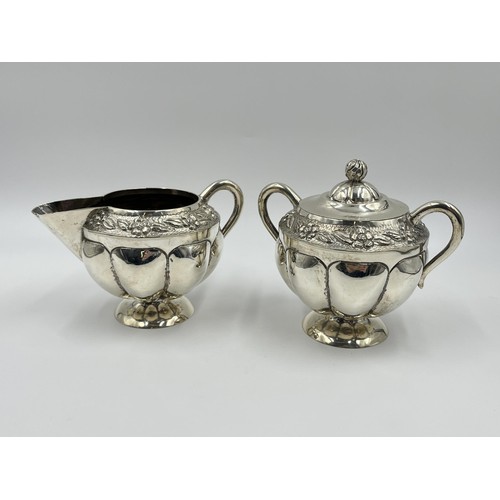 1163 - A .925 sterling silver milk jug and sugar bowl with floral design and gadrooning border - approx. gr... 