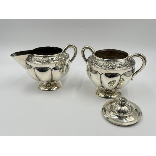 1163 - A .925 sterling silver milk jug and sugar bowl with floral design and gadrooning border - approx. gr... 