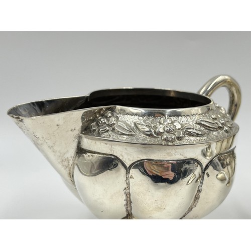 1163 - A .925 sterling silver milk jug and sugar bowl with floral design and gadrooning border - approx. gr... 