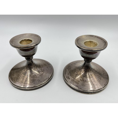 1169 - A pair of Henry Clifford Davis hallmarked Birmingham silver weighted dwarf candlesticks, dated 1961 ... 