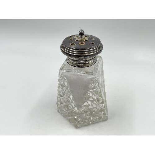 1175 - Two items, one blue cut glass scent bottle with white metal top and one cut glass salt shaker with h... 