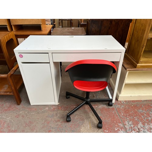 111 - Two pieces of office furniture, one IKEA white laminate desk and one red plastic swivel desk chair