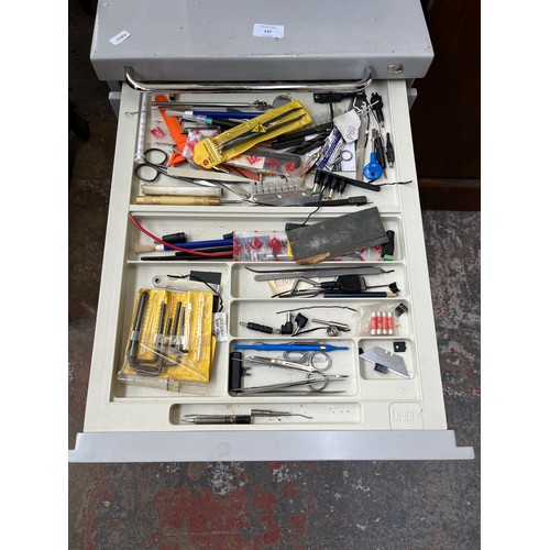 147 - A Unity grey metal four drawer tools cabinet with contents - approx. 59cm high x 42cm wide x 55cm de... 