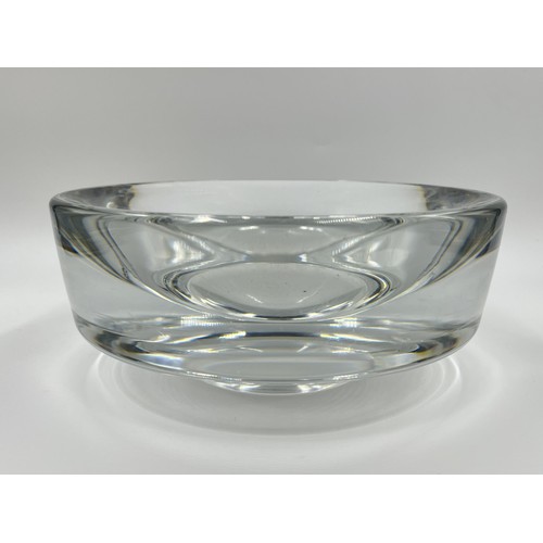 209 - A mid 20th century heavy clear glass circular footed bowl in the style of Willy Johansson for Hardel... 