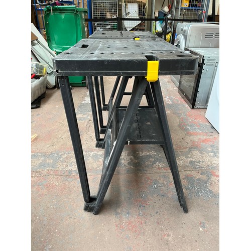 706 - Two Stanley plastic folding workbenches