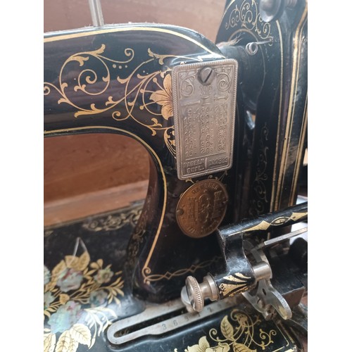 638 - A cased antique German hand-crank sewing machine