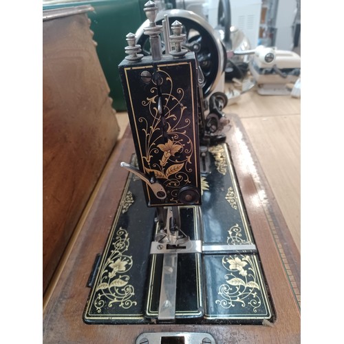 638 - A cased antique German hand-crank sewing machine