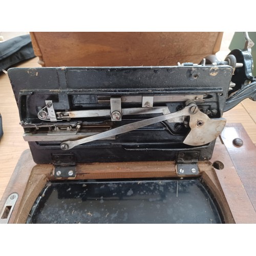 638 - A cased antique German hand-crank sewing machine