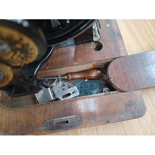 638 - A cased antique German hand-crank sewing machine