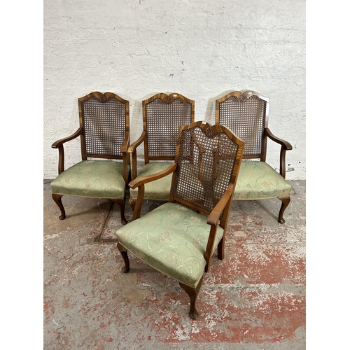 12 - A set of four walnut and rattan bergere armchairs with green floral upholstery