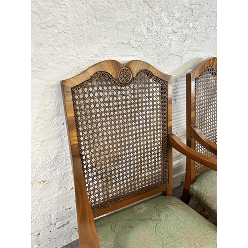 12 - A set of four walnut and rattan bergere armchairs with green floral upholstery