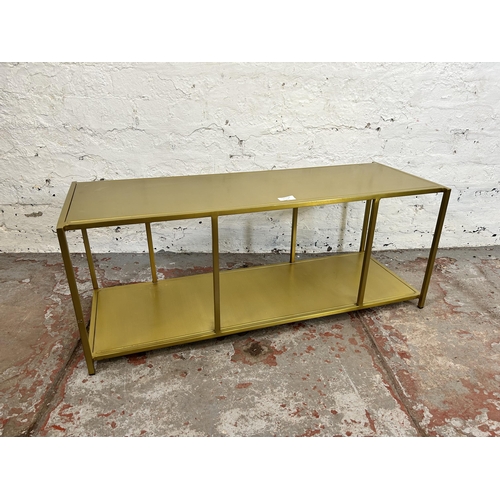 33 - A modern gilt metal rectangular two tier side table - approx. 35cm high x 90cm wide x 32cm deep