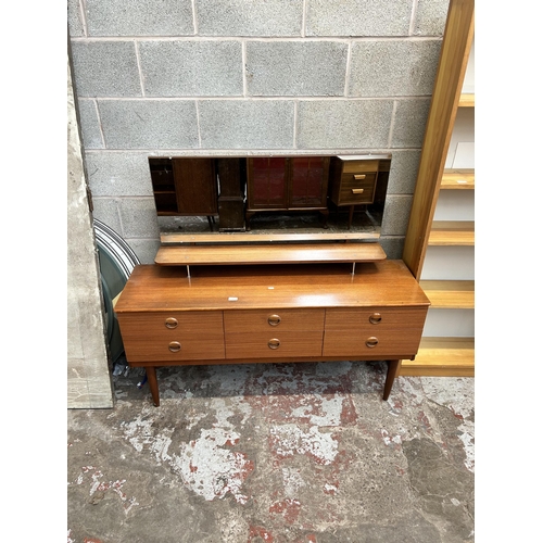 180 - A mid 20th century teak dressing table with six drawers and upper mirror