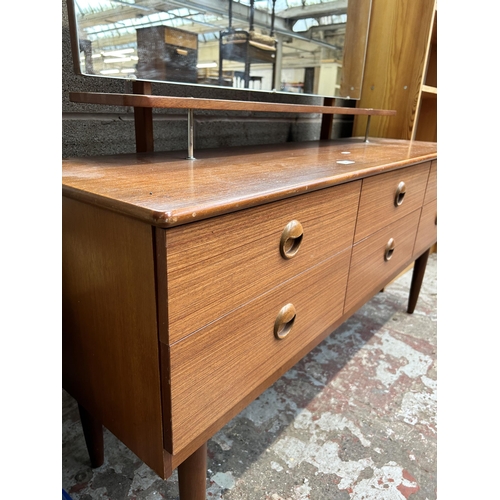 180 - A mid 20th century teak dressing table with six drawers and upper mirror