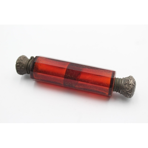 1318 - A Victorian dark cranberry glass double ended scent bottle - approx. 11cm long x 2.5cm high