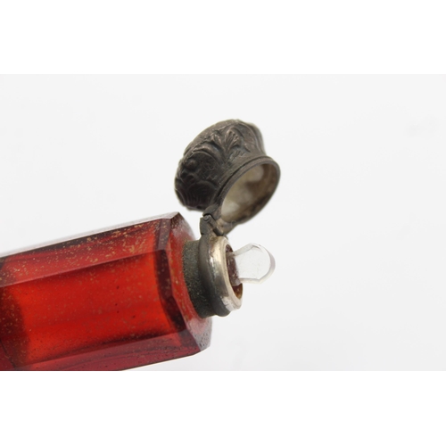 1318 - A Victorian dark cranberry glass double ended scent bottle - approx. 11cm long x 2.5cm high