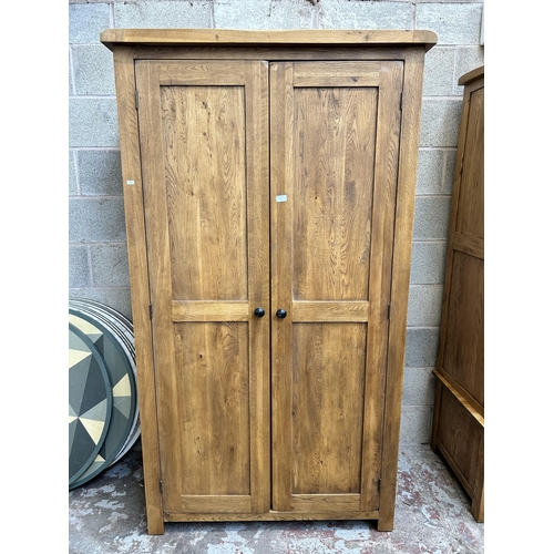 1 - A modern oak double wardrobe - approx. 193cm high x 109cm wide x 58cm deep